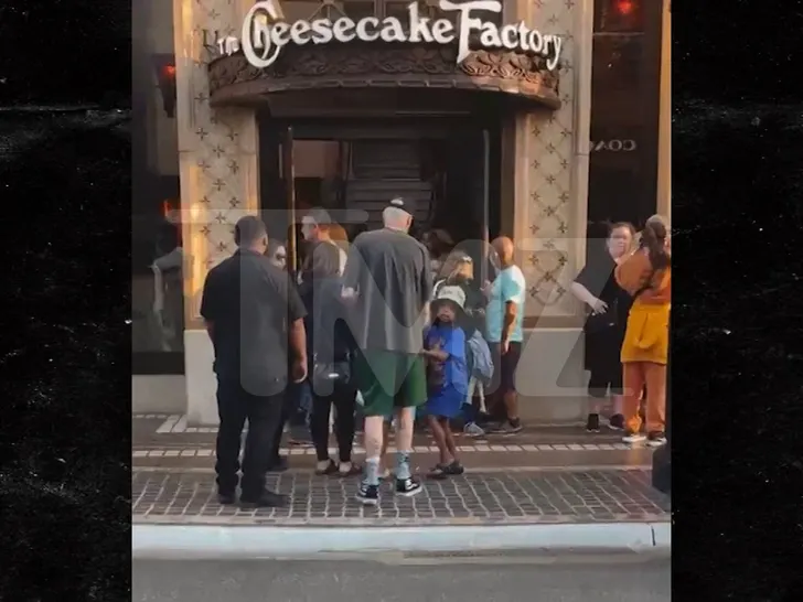 Pete Davidson with Saint West outside The Cheesecake Factory.