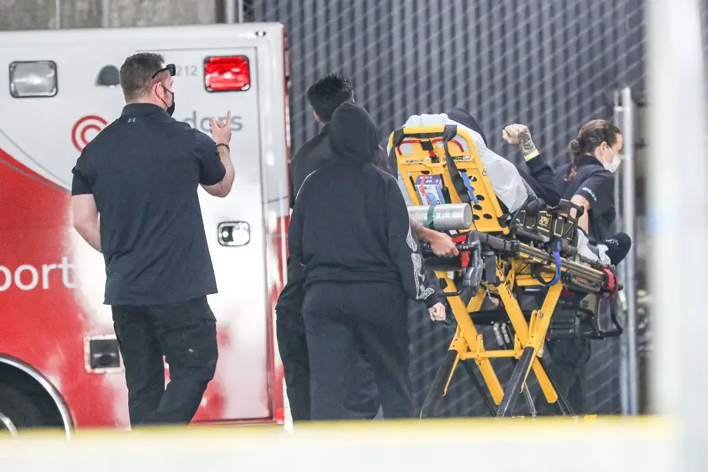 Travis Barker on a stretcher with Kourtney Kardashian