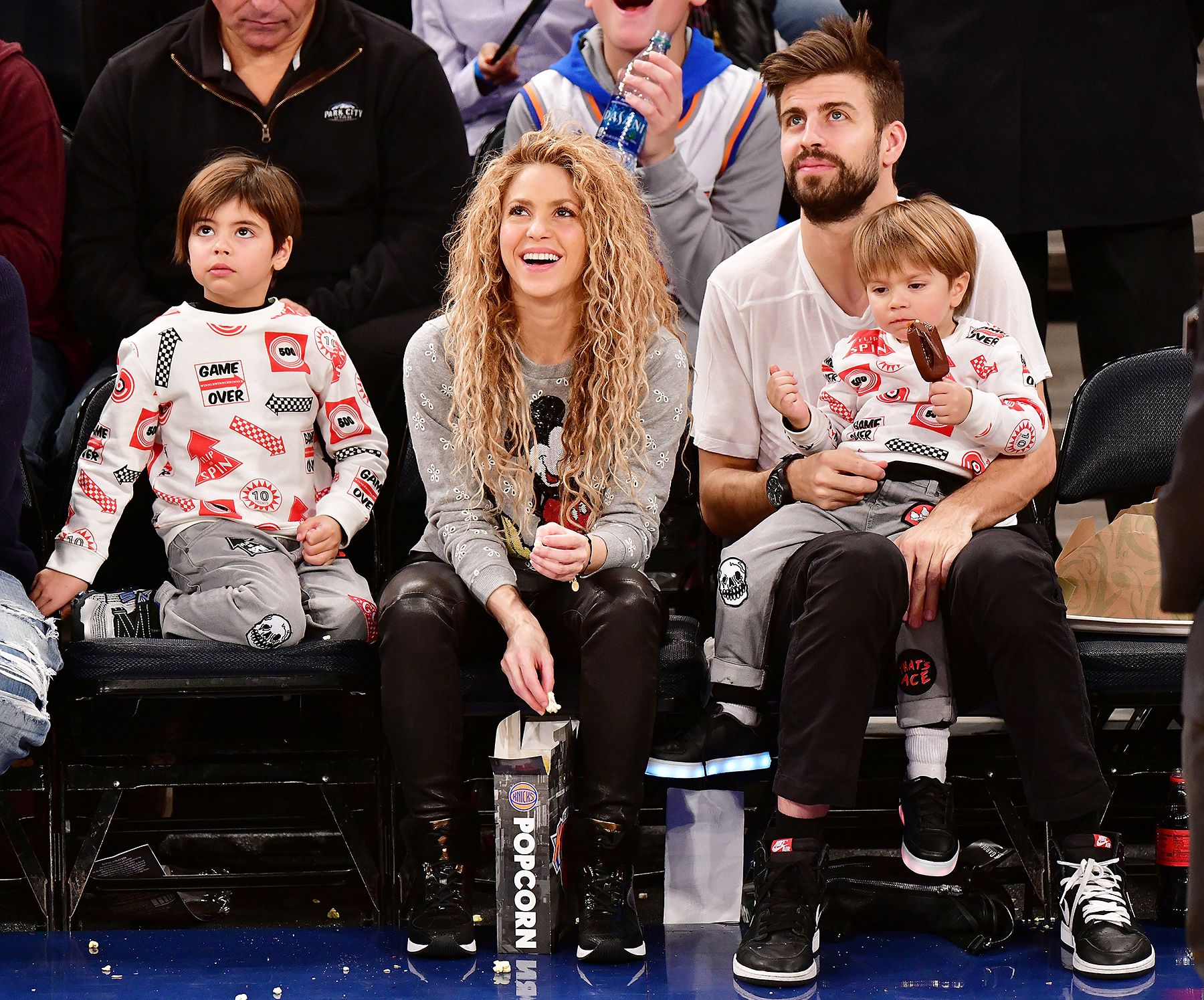 The ex-couple at a game, with their children.