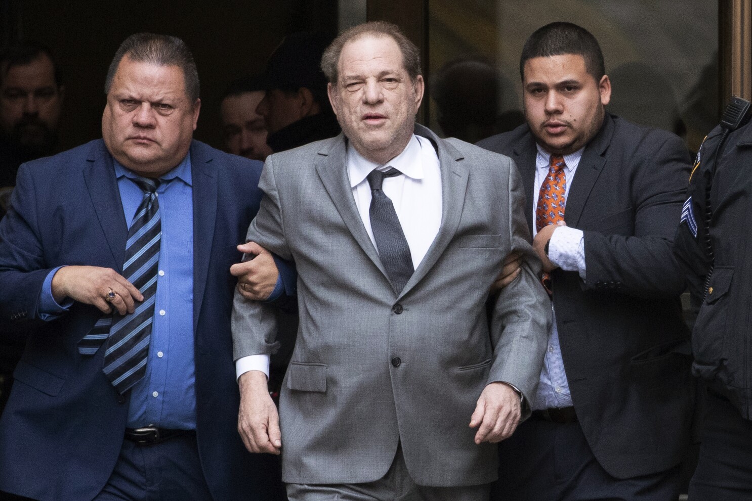 Weinstein being carried out of the court.