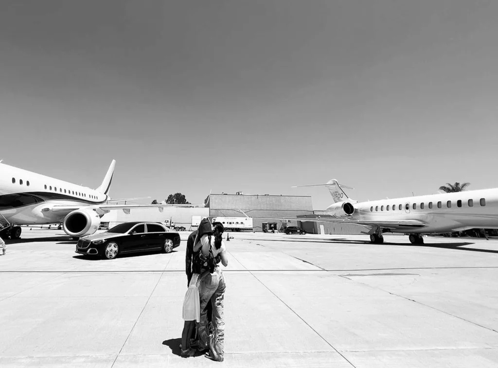 A picture of Kylie Jenner and Travis Scott in front of their private jets