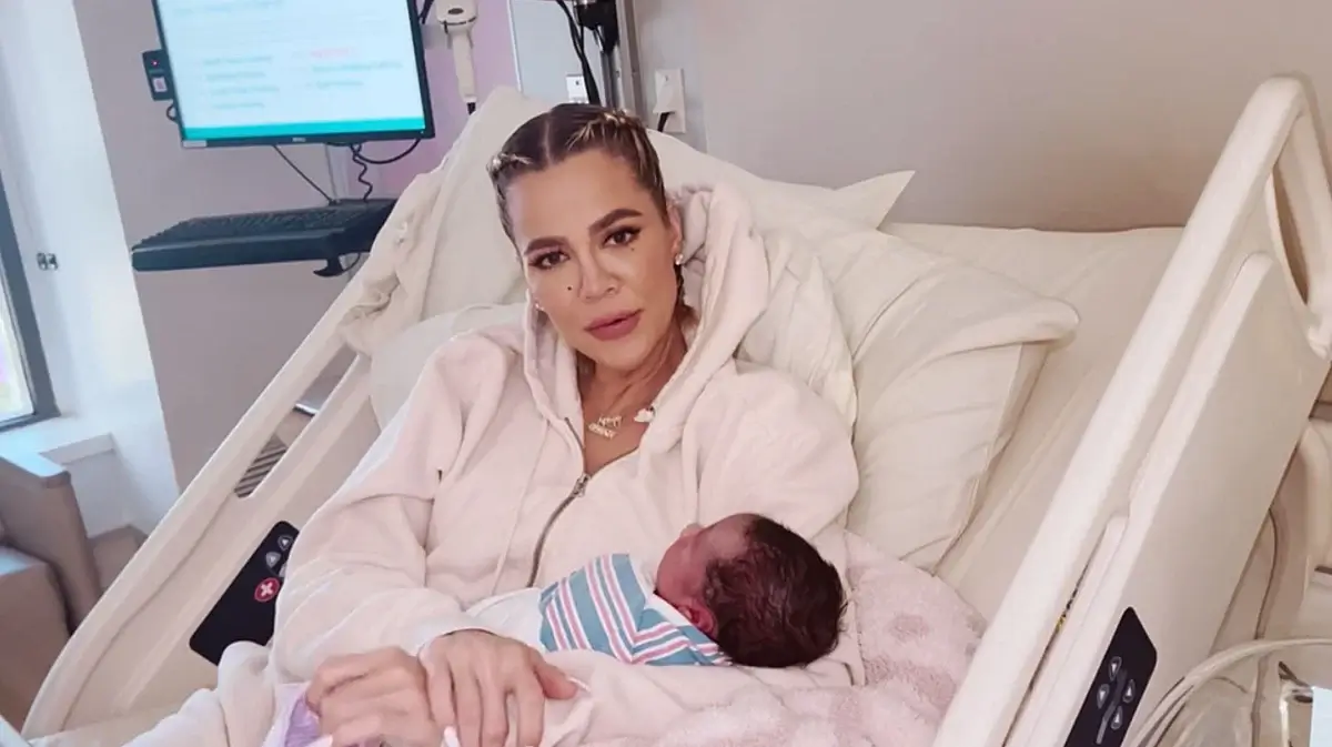 Khloe Kardashian posing with her newborn son in the hospital bed