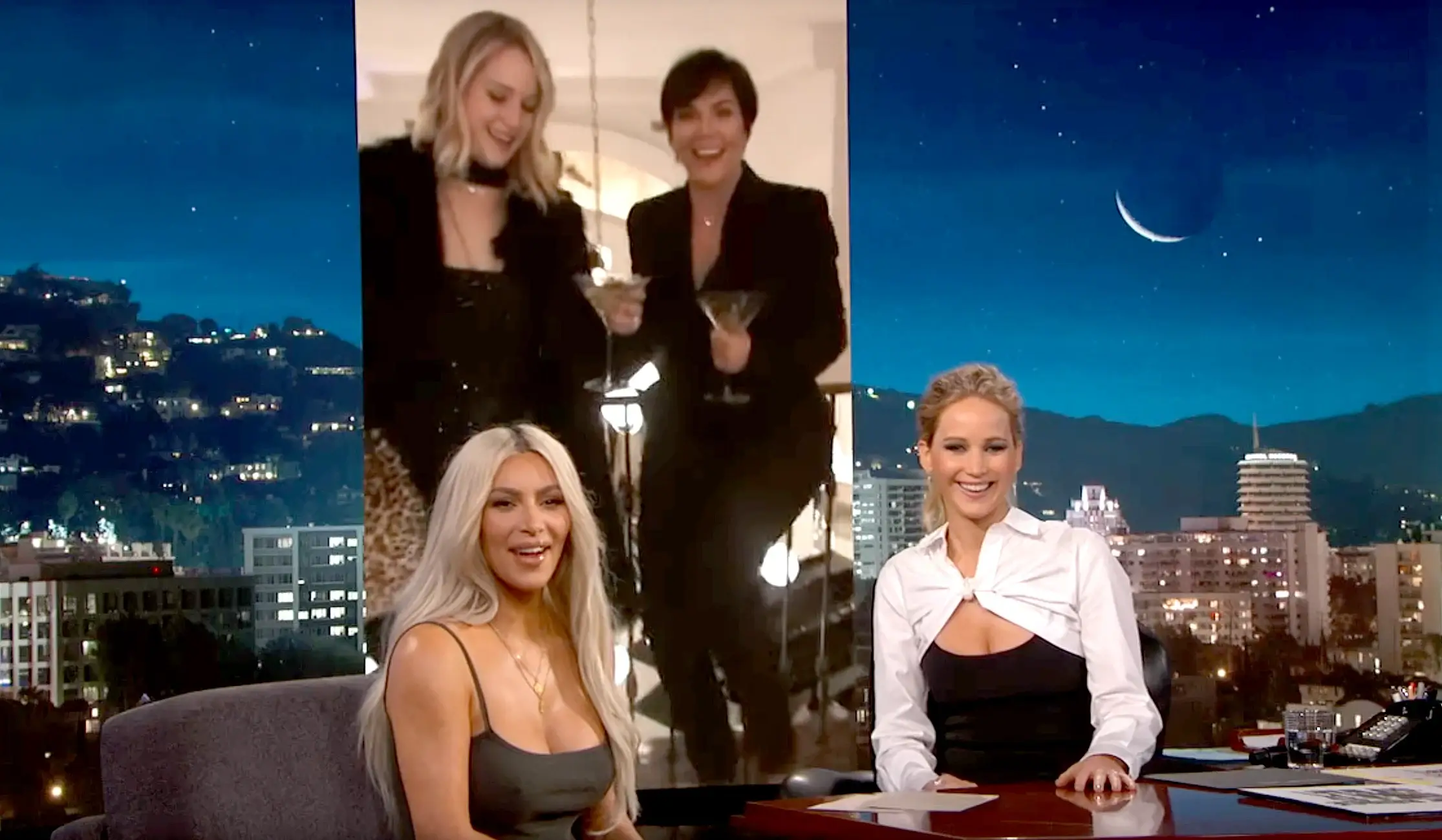 Kim Kardashian and Jennifer Lawrence watching a video